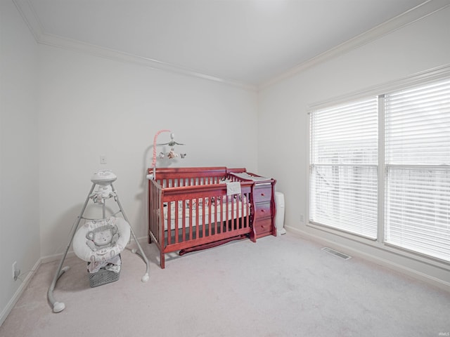 carpeted bedroom featuring a crib and ornamental molding