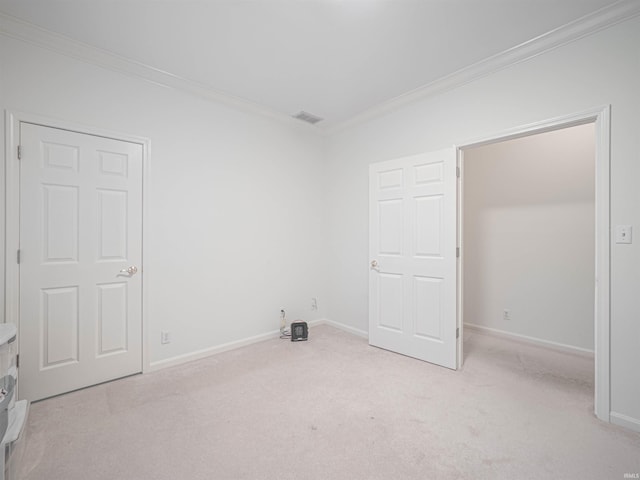 unfurnished room featuring light carpet and ornamental molding