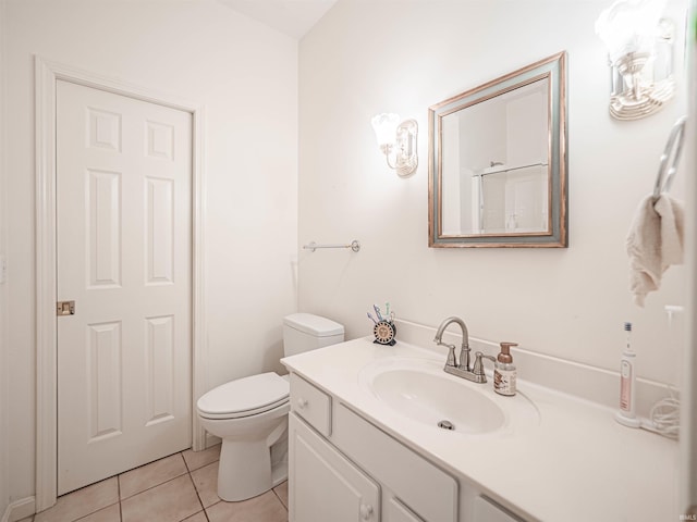 bathroom with vanity, toilet, and tile patterned flooring