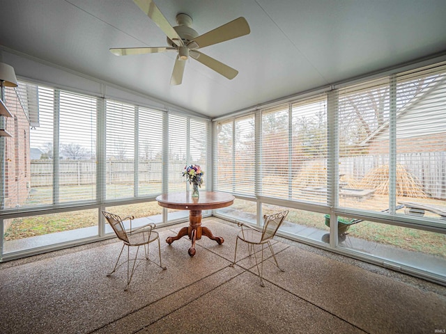 unfurnished sunroom with ceiling fan