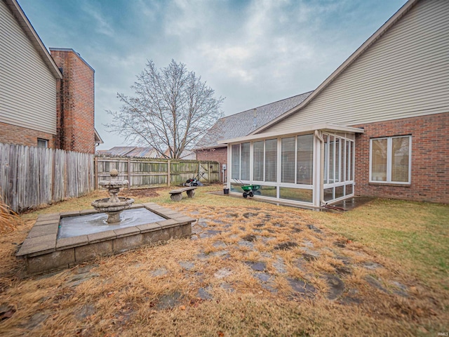 view of yard featuring a sunroom