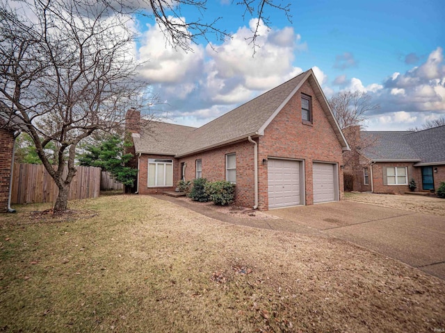 view of side of home featuring a garage and a lawn