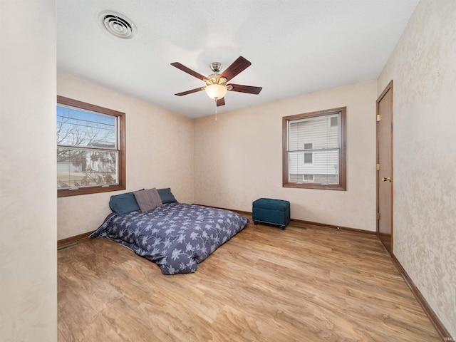 bedroom with ceiling fan and light hardwood / wood-style flooring