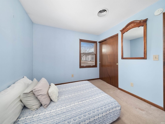 carpeted bedroom featuring a closet