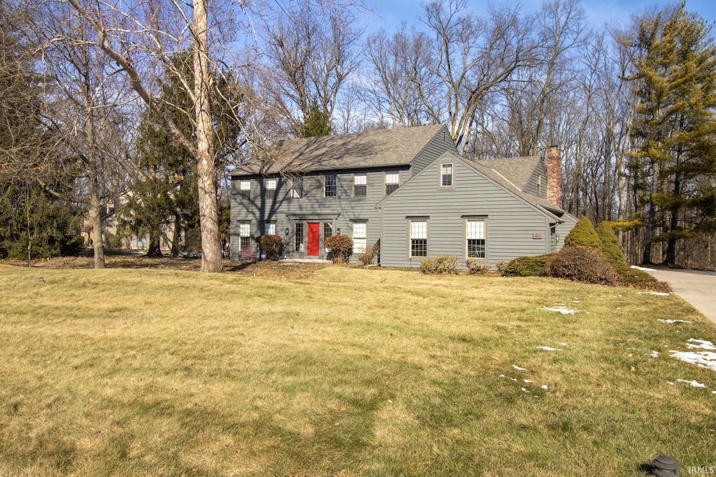 rear view of property featuring a yard