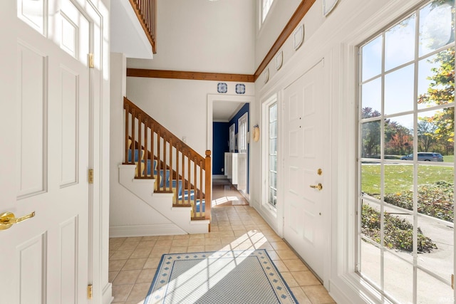 tiled foyer entrance featuring a high ceiling