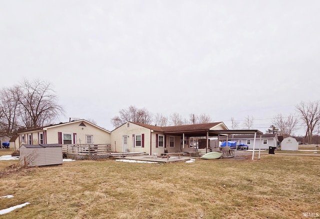 rear view of house featuring a yard