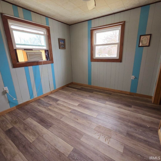 spare room featuring cooling unit and hardwood / wood-style flooring