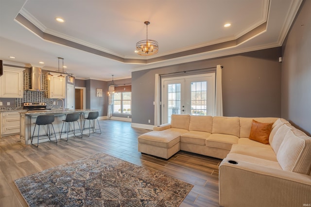 581 Silverdale Rd, Rockport, IN 47635 - living room with an inviting chandelier, a tray ceiling, wood-type flooring, ornamental molding, and french doors