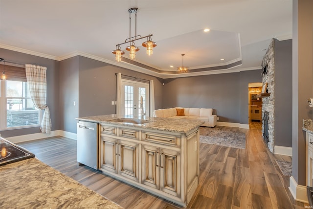 581 Silverdale Rd, Rockport, IN 47635 - kitchen with pendant lighting, a kitchen island with sink, stainless steel dishwasher, light stone countertops, and cream cabinetry
