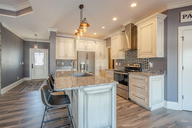 581 Silverdale Rd, Rockport, IN 47635 - kitchen featuring hanging light fixtures, appliances with stainless steel finishes, a kitchen island with sink, and wall chimney range hood