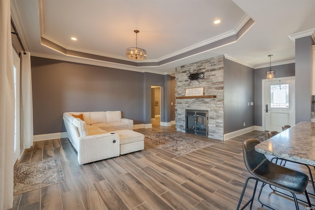 581 Silverdale Rd, Rockport, IN 47635 - living room with dark wood-type flooring, a chandelier, ornamental molding, a tray ceiling, and a fireplace
