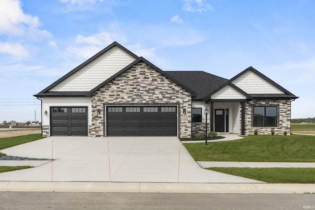 craftsman-style house featuring a garage and a front yard