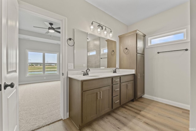 bathroom with hardwood / wood-style flooring, ceiling fan, and vanity