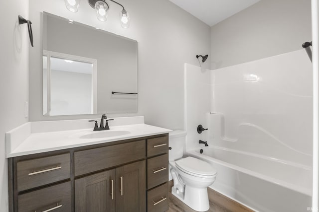 full bathroom featuring toilet, vanity, and bathtub / shower combination