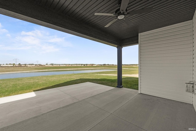 view of patio featuring a water view and ceiling fan