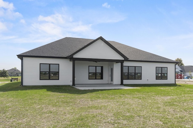 rear view of property with a yard and a patio