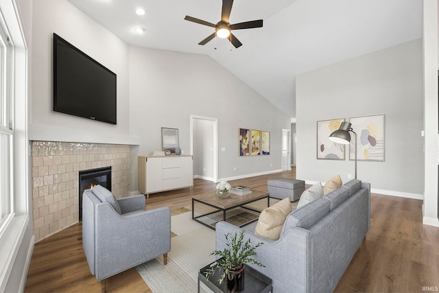 living room featuring wood-type flooring, high vaulted ceiling, and ceiling fan