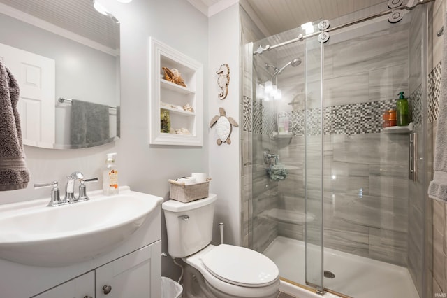 bathroom with vanity, toilet, and a shower with door