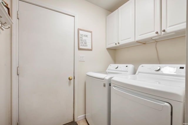 laundry area featuring washing machine and dryer and cabinets