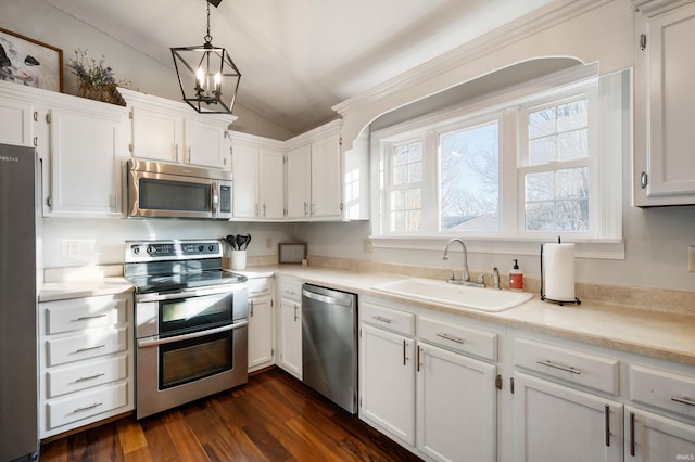 kitchen featuring pendant lighting, sink, white cabinetry, and stainless steel appliances