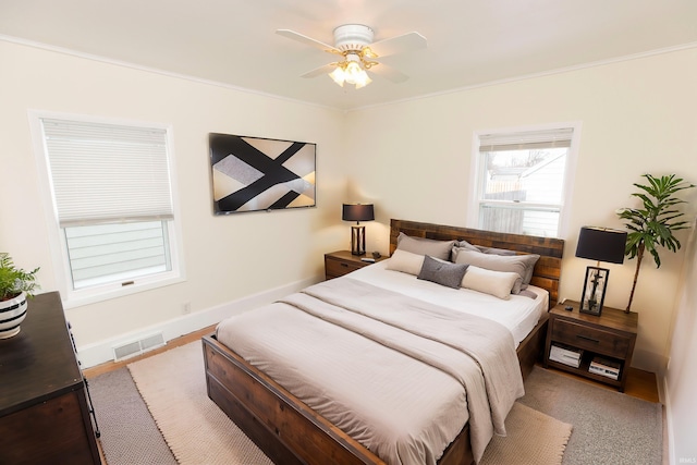 bedroom featuring ornamental molding and ceiling fan