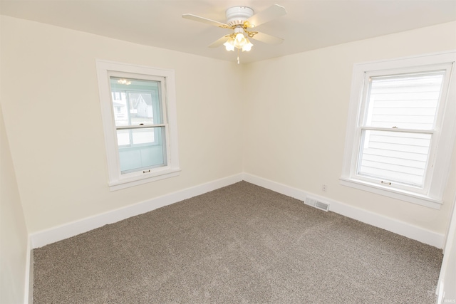 empty room featuring carpet flooring and ceiling fan