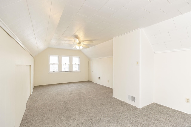 bonus room with vaulted ceiling, carpet flooring, and ceiling fan