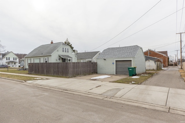 view of property exterior featuring a garage and an outdoor structure