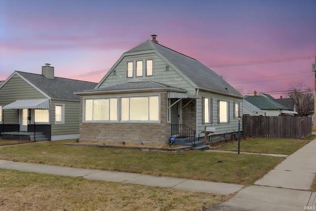 bungalow-style house with a yard