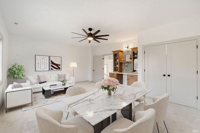 carpeted dining area featuring ceiling fan