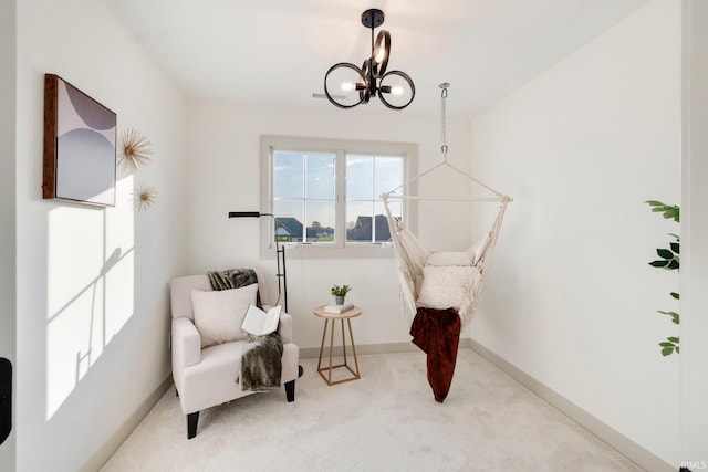 sitting room with light carpet and a chandelier