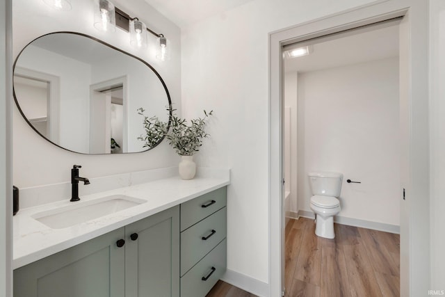 bathroom featuring hardwood / wood-style flooring, vanity, and toilet