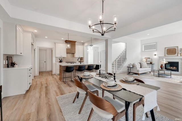 dining area with a notable chandelier and light wood-type flooring