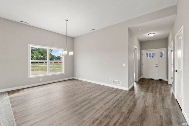 interior space with an inviting chandelier and dark wood-type flooring