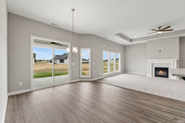 unfurnished living room with a healthy amount of sunlight, hardwood / wood-style floors, and a fireplace