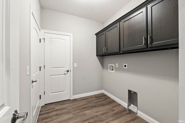 clothes washing area with cabinets, hookup for a washing machine, hookup for an electric dryer, and dark hardwood / wood-style flooring