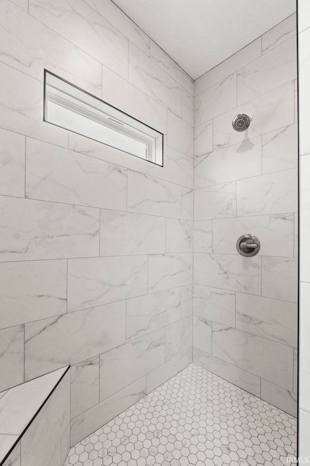 bathroom with tiled shower