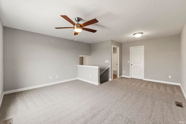 unfurnished living room with ceiling fan and carpet flooring