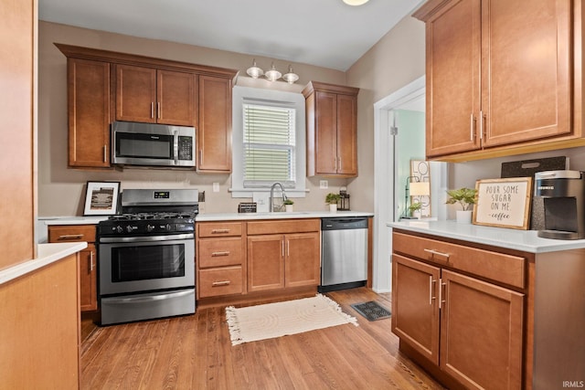 kitchen featuring sink, stainless steel appliances, and light wood-type flooring