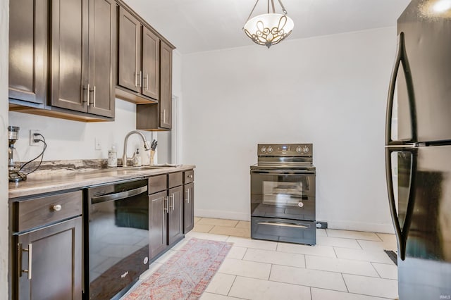 kitchen featuring dark brown cabinetry, sink, light tile patterned floors, pendant lighting, and black appliances