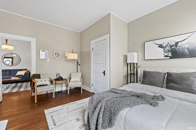 bedroom with dark hardwood / wood-style flooring