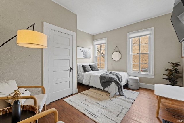 bedroom with dark hardwood / wood-style flooring