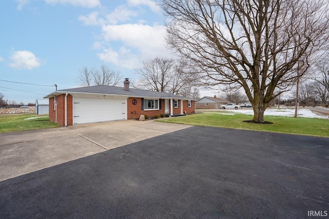 single story home featuring a garage and a front yard