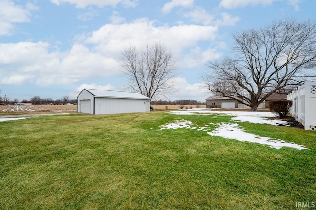 view of yard featuring an outbuilding and a garage