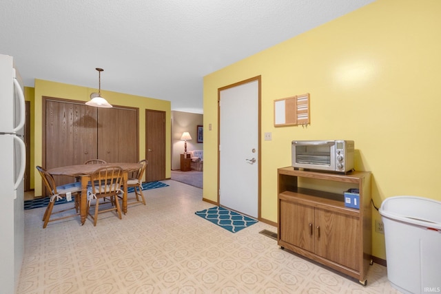 dining area with a textured ceiling