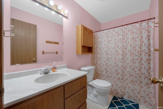 bathroom with vanity, toilet, and curtained shower