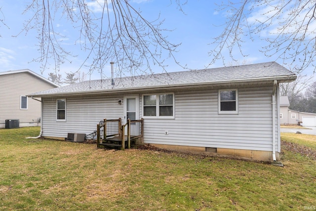 rear view of property with a yard and central AC