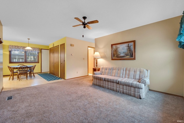 carpeted living room featuring ceiling fan