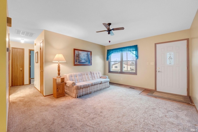 carpeted living room featuring ceiling fan